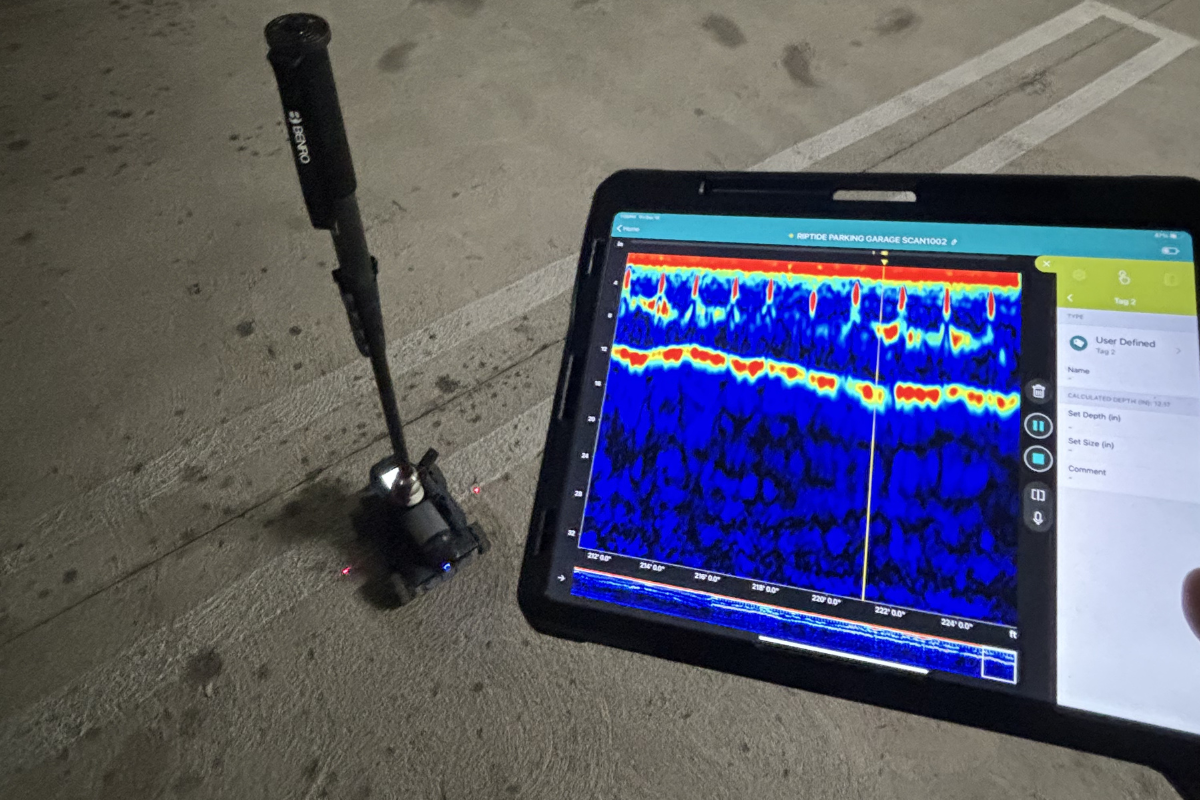Proceq GP8000 portable concrete GPR scanner used in parking garage with tablet displaying subsurface profile for rebar and conduit detection.