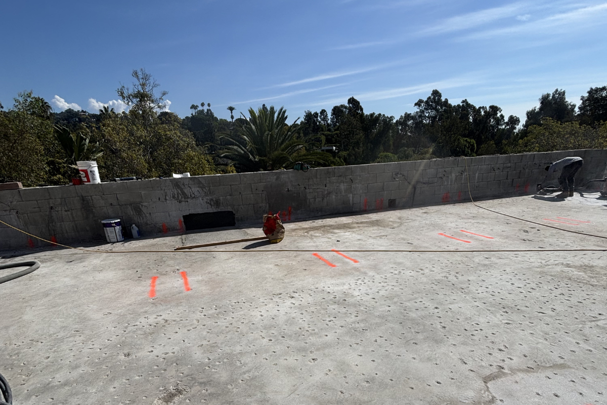 Concrete scanning with GPR markings on rooftop slab showing safe drilling points and technician at work in Southern California construction site.