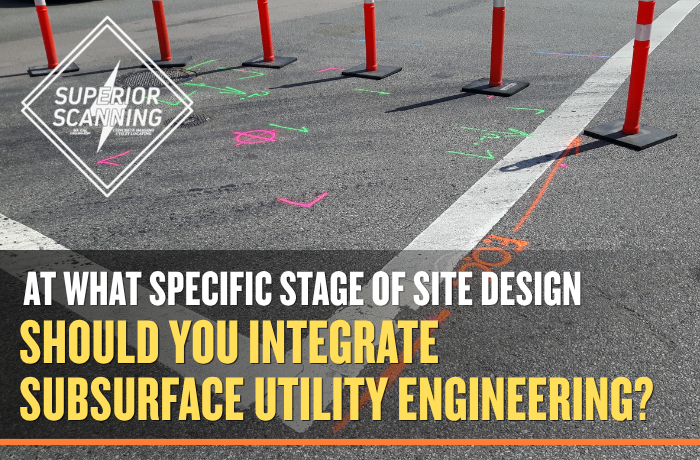 Color-coded utility markings and safety cones on pavement showing subsurface utility engineering used before site design and excavation.