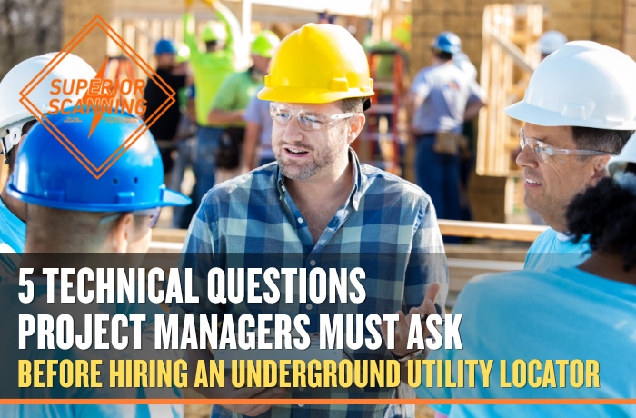 Project managers in hard hats discussing underground utility locating questions on a construction site before excavation.