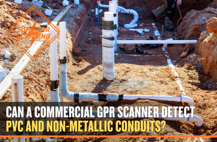 A construction site with plumbing pipes being laid in trenches dug into the dirt.