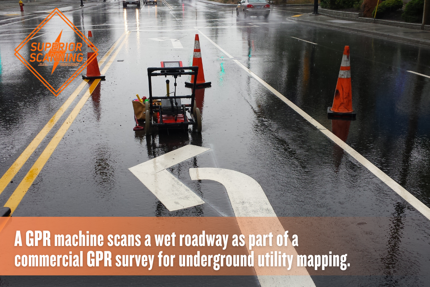 Ground penetrating radar equipment scanning a wet roadway with traffic cones during a utility mapping survey.