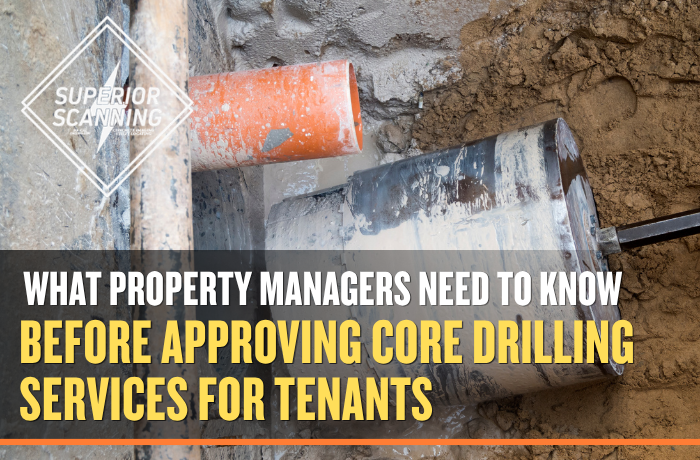 A large drill bit is being used to bore a hole through concrete, with an orange pipe visible in the background.