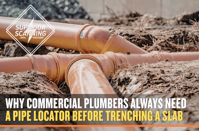 Orange PVC pipes are laid in a trench with soil and gravel.