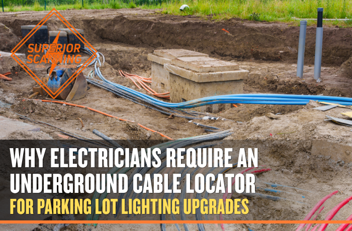 Construction site with trenches dug and various colored cables, including blue, green, orange, and red, laid out and connected to concrete junction boxes.