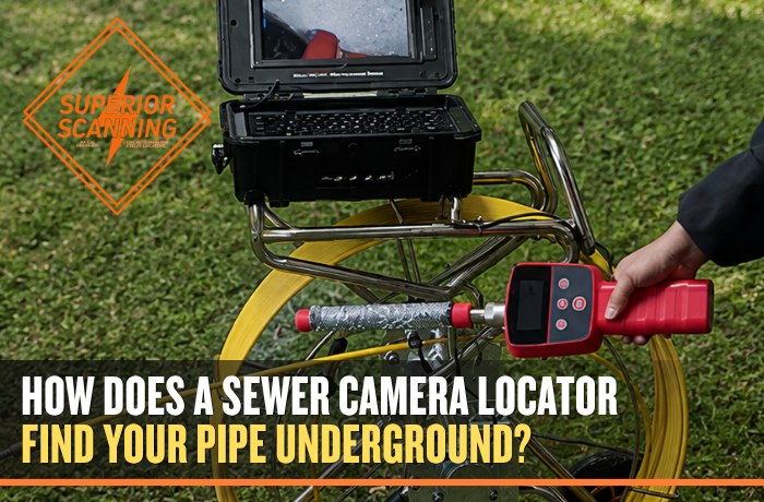 Sewer inspection camera system with cable reel, monitor, and locator equipment set up on a grassy area.